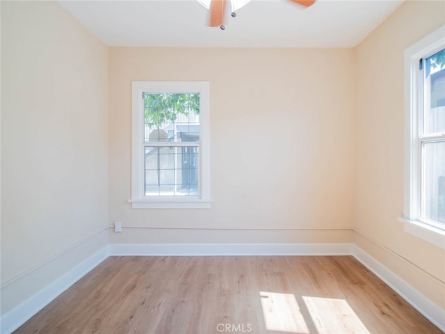 unfurnished room with ceiling fan, plenty of natural light, and light hardwood / wood-style floors