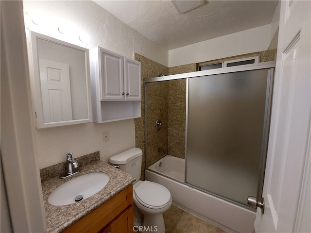 full bathroom with tile floors, vanity, toilet, and shower / bath combination with glass door