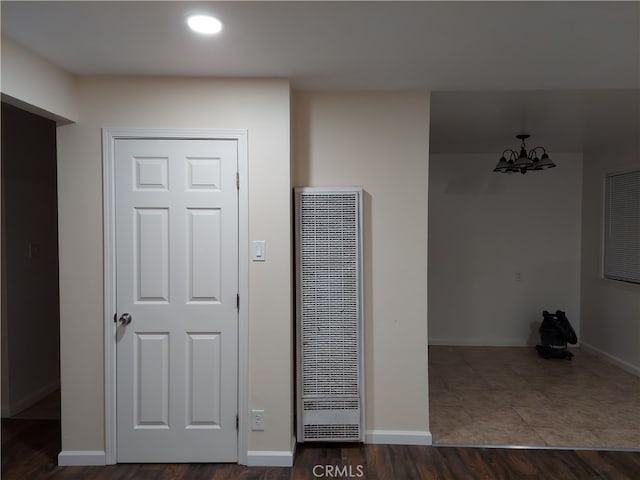 foyer entrance featuring a notable chandelier and dark tile floors