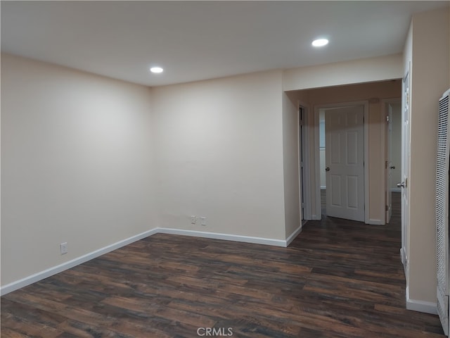 spare room with dark hardwood / wood-style flooring