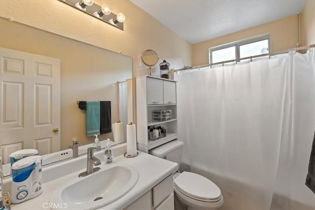 bathroom with shower / tub combo, toilet, and vanity