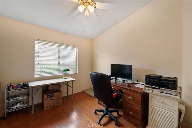 home office featuring wood finished floors, ceiling fan, and vaulted ceiling