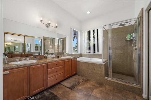 bathroom featuring vanity, a wealth of natural light, and independent shower and bath