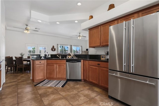 kitchen featuring ceiling fan, sink, kitchen peninsula, and stainless steel appliances