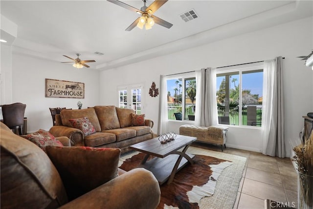 living room with ceiling fan, light tile patterned floors, and french doors