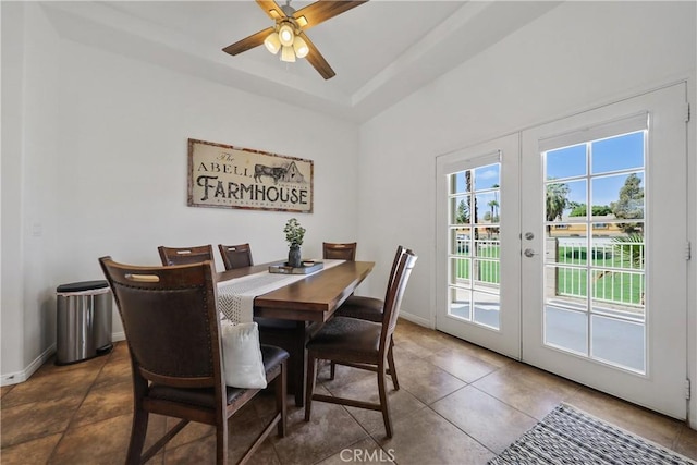 dining room featuring ceiling fan, french doors, and dark tile patterned floors