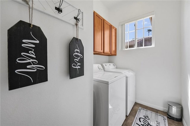 washroom featuring washer and dryer and cabinets