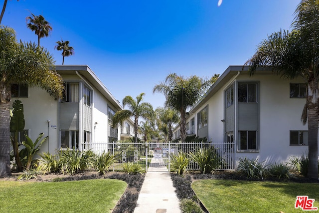 view of home's community with a yard