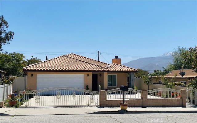 view of front facade featuring a mountain view and a garage