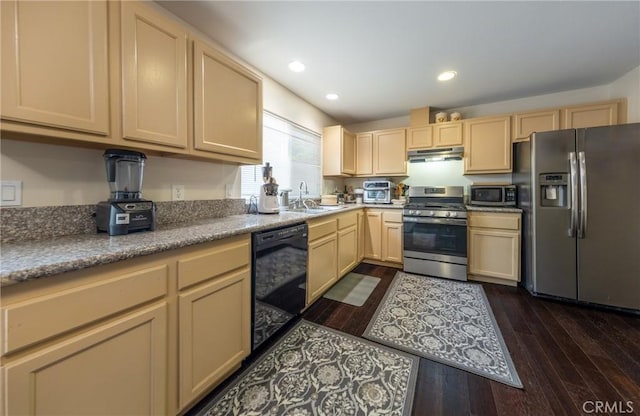 kitchen featuring sink, stainless steel appliances, light brown cabinetry, and dark wood-type flooring