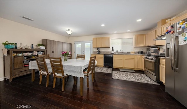 kitchen with sink, light brown cabinetry, dark wood-type flooring, and appliances with stainless steel finishes