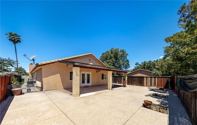 back of house with french doors and a patio