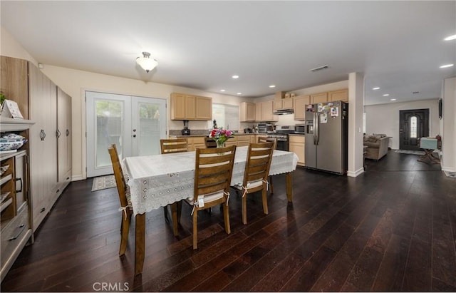 dining space with a wealth of natural light, french doors, and dark hardwood / wood-style floors