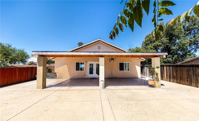 rear view of house featuring french doors and a patio