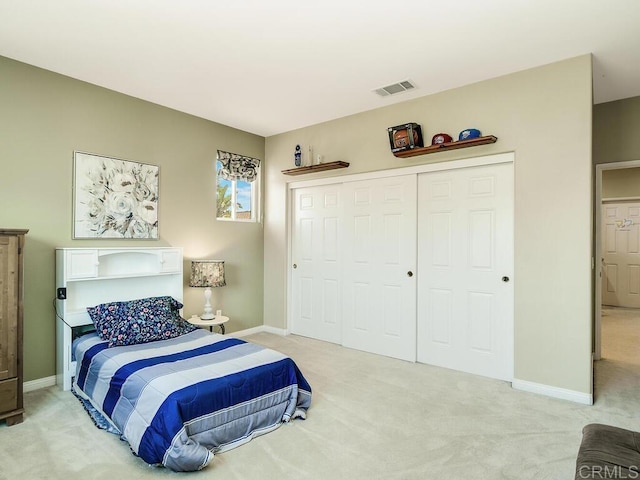 bedroom with light colored carpet and a closet