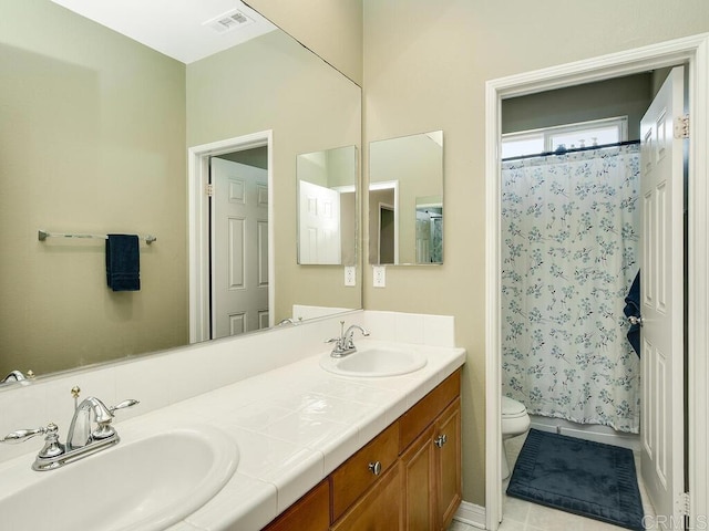 full bathroom with shower / bath combination with curtain, vanity, toilet, and tile patterned flooring