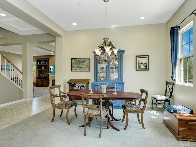 dining space with light carpet and a chandelier