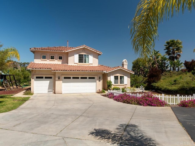 mediterranean / spanish house with a garage