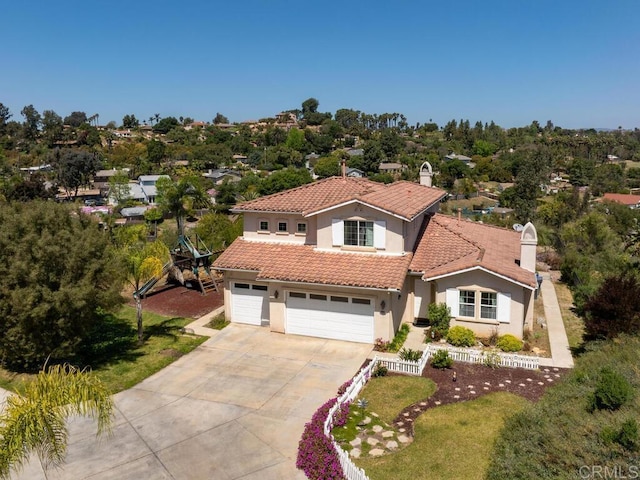 mediterranean / spanish-style house with a garage