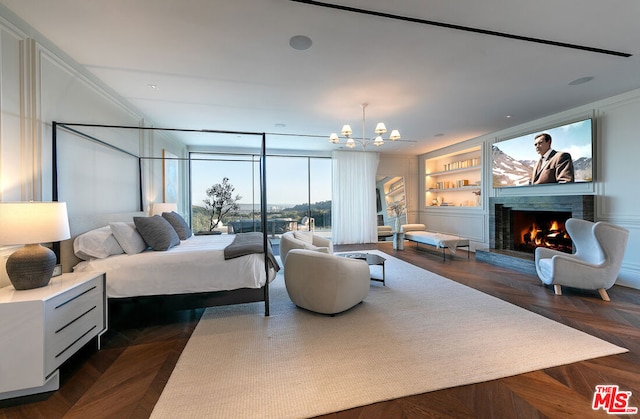 bedroom with a premium fireplace, dark parquet floors, and a chandelier