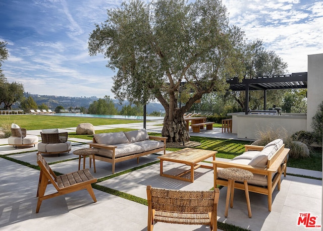 view of patio with exterior kitchen, a pergola, an outdoor living space, a water view, and a bar