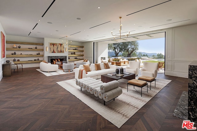 living room with a notable chandelier and dark parquet floors