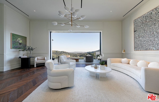 living room with a mountain view, a chandelier, and parquet flooring