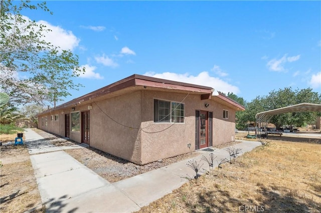 view of property exterior with a carport