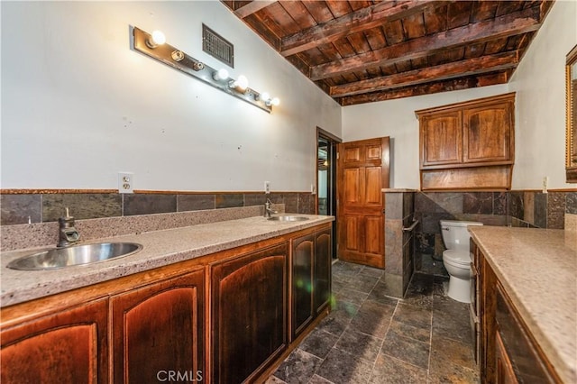 bathroom featuring wood ceiling, vanity, beam ceiling, tile walls, and toilet