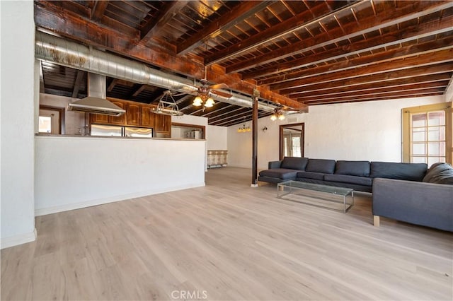 unfurnished living room featuring beamed ceiling, wooden ceiling, and light hardwood / wood-style flooring