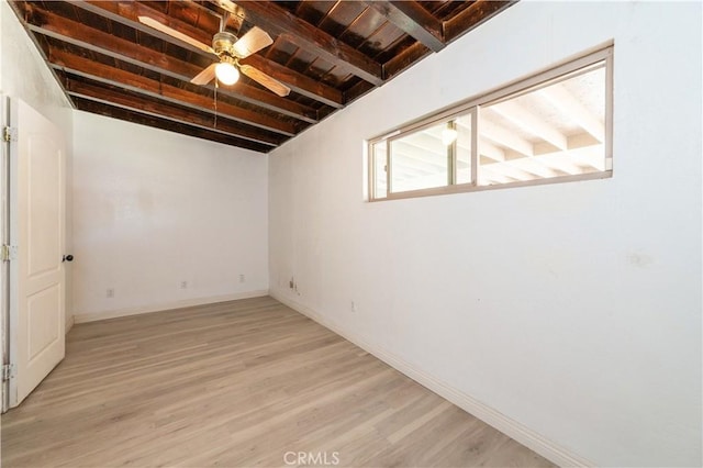 basement with light hardwood / wood-style floors, ceiling fan, and wooden ceiling