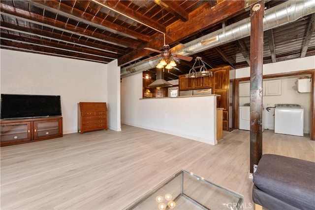 living room featuring beam ceiling, light wood-type flooring, and washer / clothes dryer