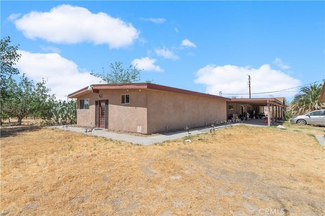 view of side of home featuring a carport