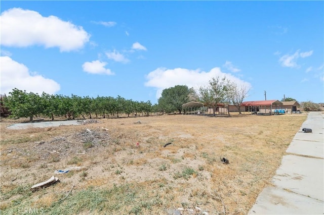 view of yard with a rural view