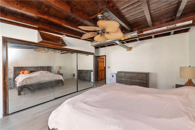 bedroom with ceiling fan, light hardwood / wood-style flooring, beamed ceiling, and wooden ceiling