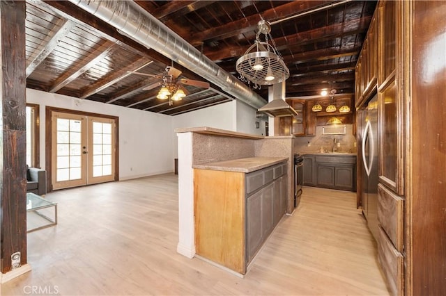 kitchen featuring french doors, beamed ceiling, light hardwood / wood-style floors, and range hood