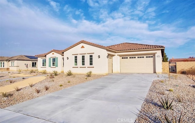 mediterranean / spanish-style home with a garage