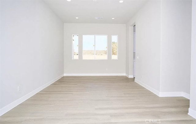 spare room with light wood-type flooring