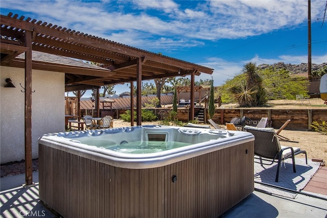 view of terrace featuring a hot tub and a pergola