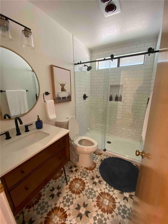 bathroom featuring a shower with door, a textured ceiling, tile floors, toilet, and vanity