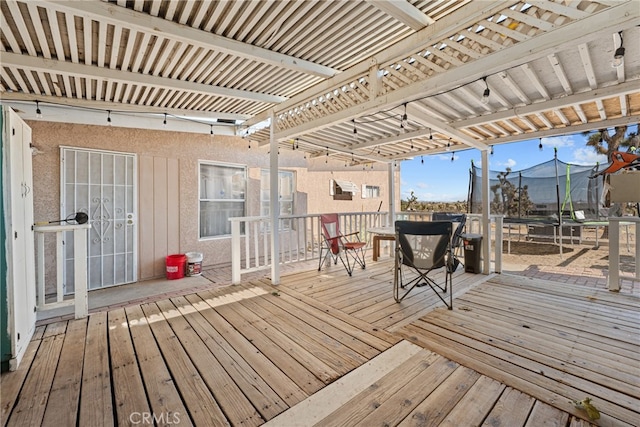 wooden terrace with a trampoline