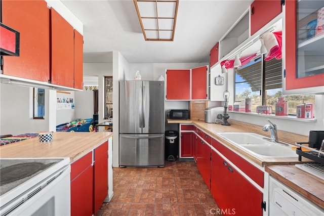 kitchen with white electric range, stainless steel refrigerator, and sink