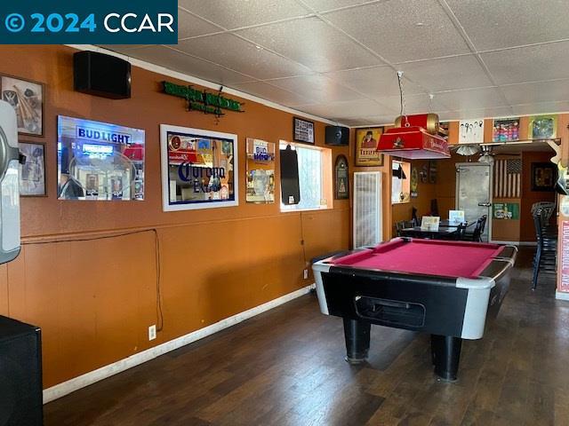 rec room with pool table, dark hardwood / wood-style floors, and a paneled ceiling