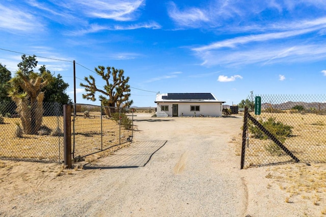 ranch-style house with solar panels