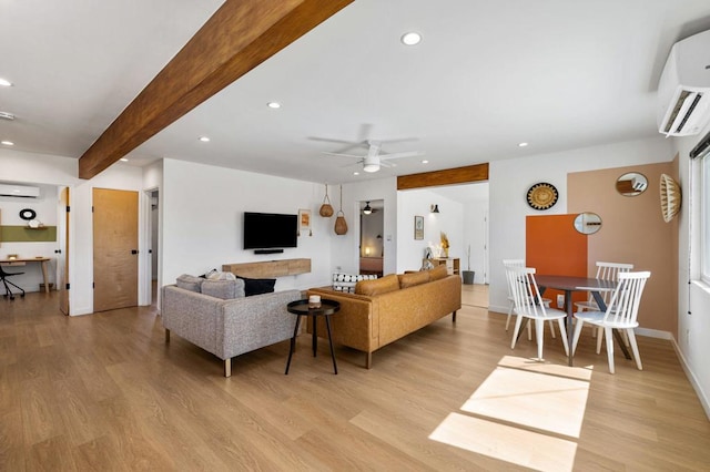 living room with beam ceiling, light hardwood / wood-style flooring, an AC wall unit, and ceiling fan