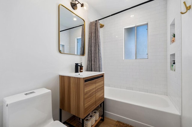 full bathroom featuring hardwood / wood-style floors, vanity, toilet, and shower / tub combo with curtain