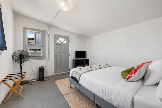 bedroom featuring concrete floors and vaulted ceiling