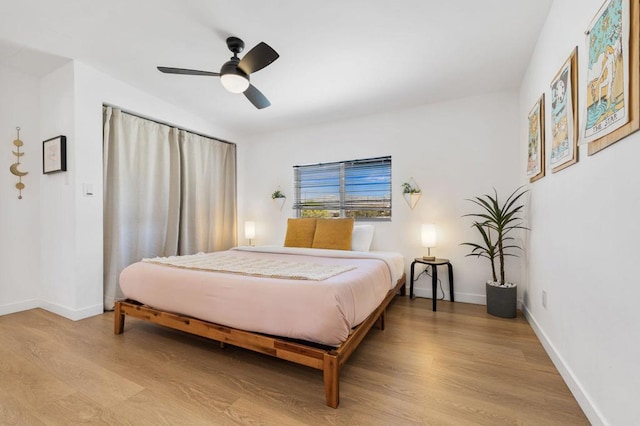 bedroom with ceiling fan and light hardwood / wood-style flooring