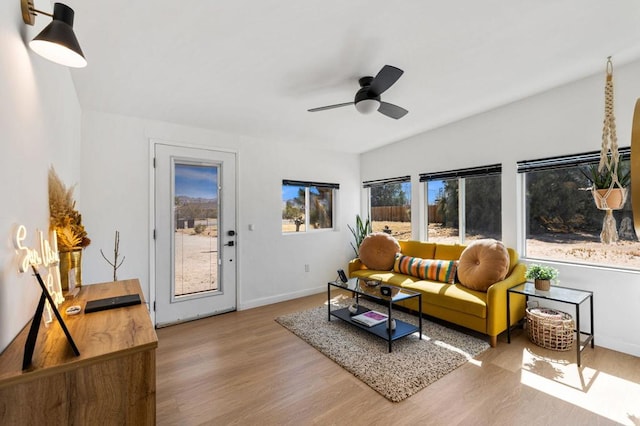 living room with ceiling fan and light hardwood / wood-style flooring