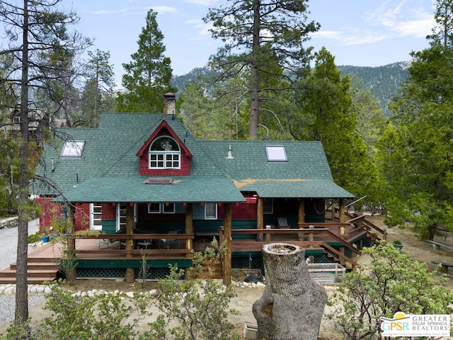 view of front of property with a wooden deck